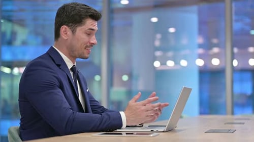 Man in Suit Video Call in Office at Night