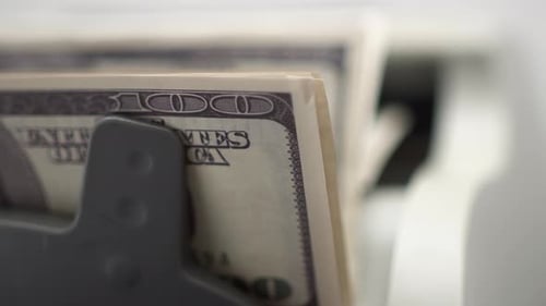 Machine Counts Stack of One Hundred Dollar Bills