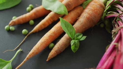 Video of fresh vegetables of beetroot and carrot with copy space over grey background
