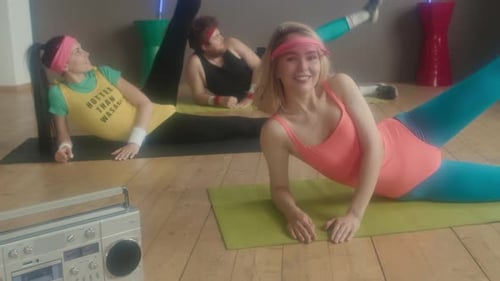 Group Doing 80s Workout Exercises in Studio