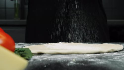 Flour is falling on yeast dough