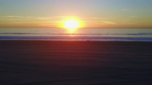 Aerial drone uav view of a sunset over the beach and ocean