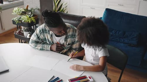 Top View of African American Man and Girl Drawing Together at Home Kid Showing His Father How to