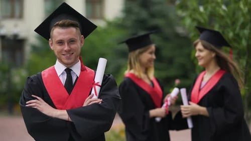 Male Graduate Smiling for Camera With Folded Arms Happy Future