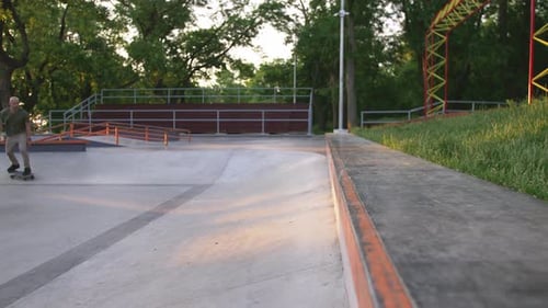 Skateboarder Doing a Tricks in a Concrete Skate Park