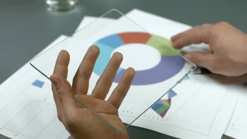 Hands Use Glass Tablet To Analyze Charts