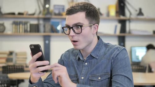 Man Reacts in Shock to Phone Content