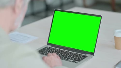 Old Man Using Laptop with Green Screen
