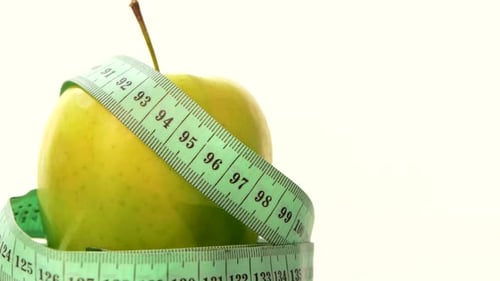 Green, Fresh Apple with Measuring Tape on Black, Rotation, Reflection, Close Up