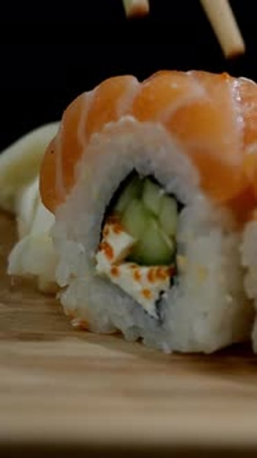 Chopsticks Grabbing Salmon Sushi Roll