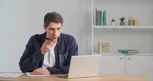 Young Adult Man Using Voice Command in Office