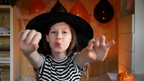 Girl Dressed as Witch Reaches Towards Camera