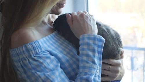 Woman Holding Pet Bunny Close Indoors Daytime