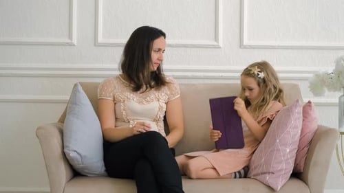 Mother and Daughter Using a Tablet at Home