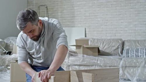 Man Assembling Furniture at Home