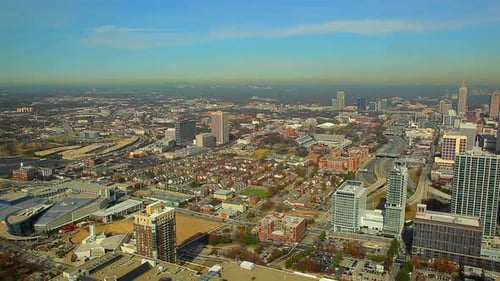 A high angle, extreme wide, timelapse shot of Atlanta, Georgia buildings and freeway at daytime.