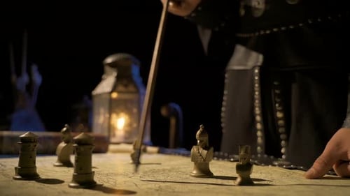 Person Plans Strategy on Map with Chess Pieces