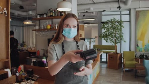 Customer Paying with NFC Technology By Smart Watch Contactless on Terminal in Modern Cafe Barman