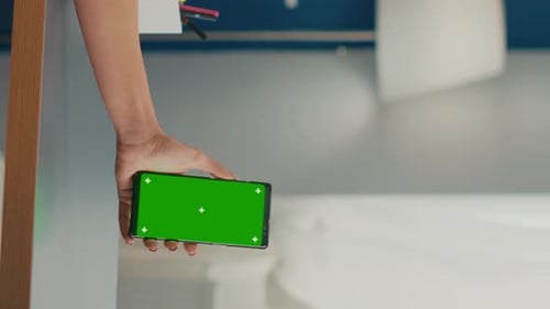 Vertical Video Social Media Woman Holding Touchscreen Phone with Mock Up Green Screen
