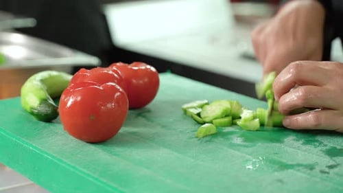 The chef is slicing cucumbers.