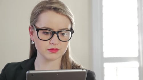 Woman Using Tablet Device Indoors