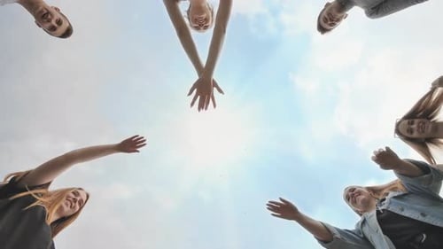 Happy Young Friends Joining Hands in Circle