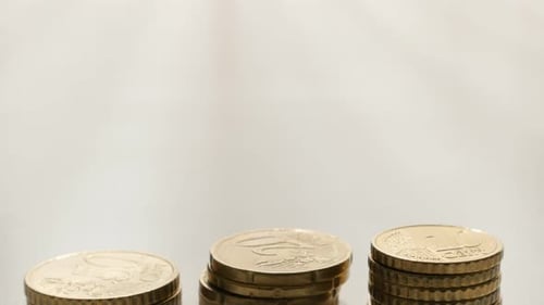 Stacks of Shiny Euro Coins on White