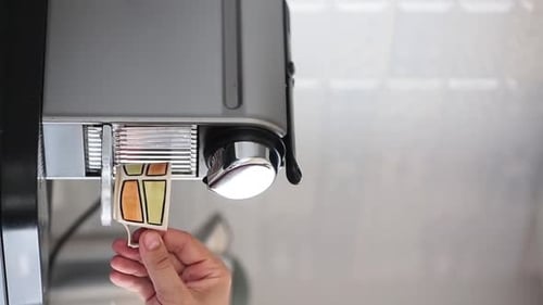 Vertical Video - View of a Home Coffee Macine Preparing Coffee.