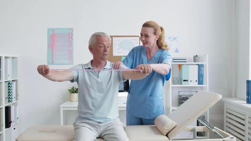 Senior Man Exercising with Physical Therapist
