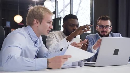 Team Collaboration with Laptop in Modern Workplace