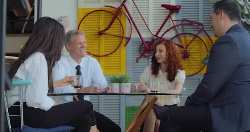 Group of People Talking at an Outdoor Cafe