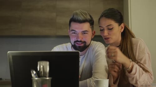 Couple Using Laptop Together at Home