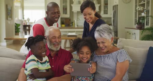 Three generation family using digital tablet at home