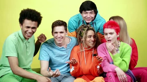 Friends Laughing Together Against a Yellow Background