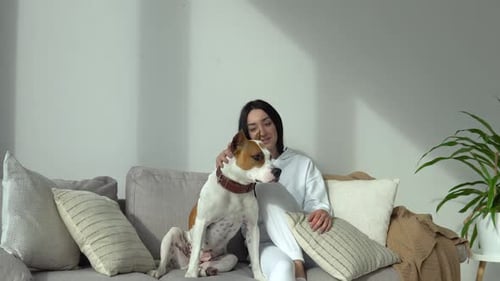 Woman Posing with Dog on Couch Indoors