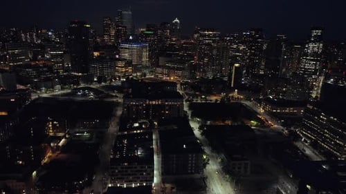 City Lights Aerial Of Downtown Skyline Skyscraper Buildings Lit At Night