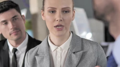 Professionals Discuss Business Strategy in Modern Office