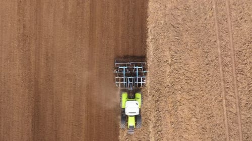 The Tractor Plows the Field Prepares for Crops