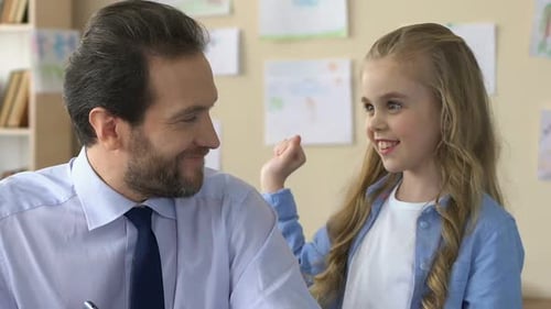 Girl Gives Father Homemade Card for Father's Day