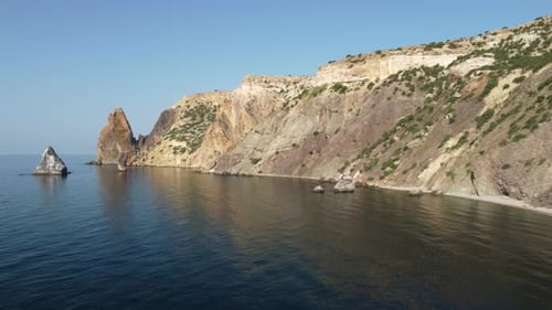 Aerial View From Above on Calm Azure Sea and Volcanic Rocky Shores