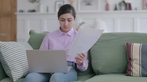 Young Adult Works on Laptop at Home