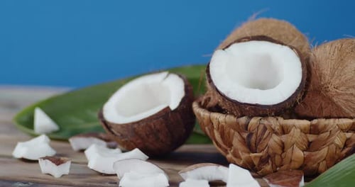 Halved and Whole Coconuts in Basket