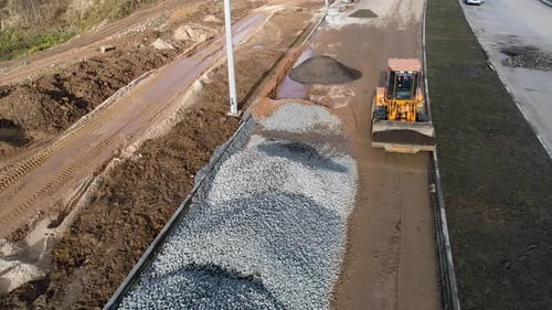 Heavy Special Cargo Vehicles Build a New Road for Transport. Hot Asphalt. Drone