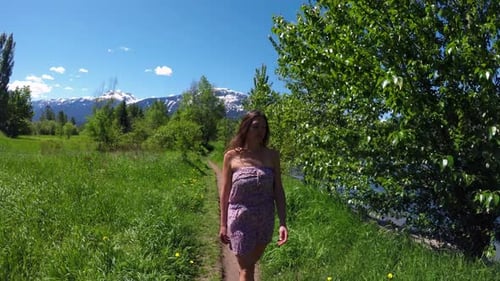 Woman walking on path in forest