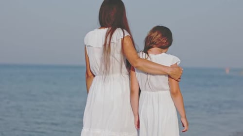 Mom and Daughter Walking By the Sea