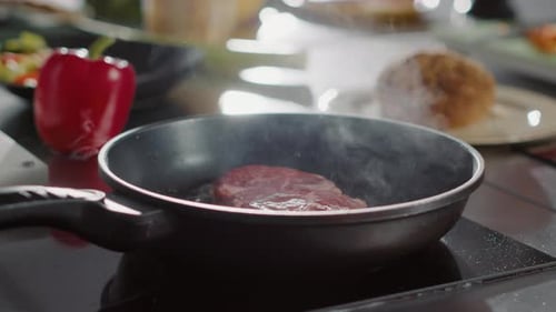 Steak Cooking in Pan on Stove