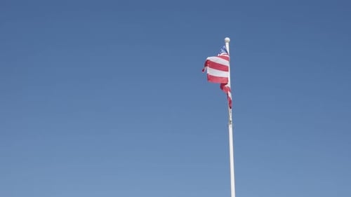 American Flag Waving Against a Clear Blue Sky