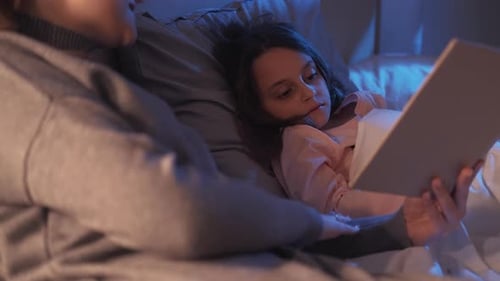 Child Listening to Bedtime Story at Night