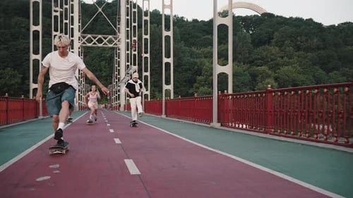 Young Skaters on an Empty Footbridge Do Tricks and Ride Boards