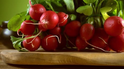 Vibrant Red Radishes on a Wooden Cutting Board